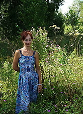 In blue dress in field